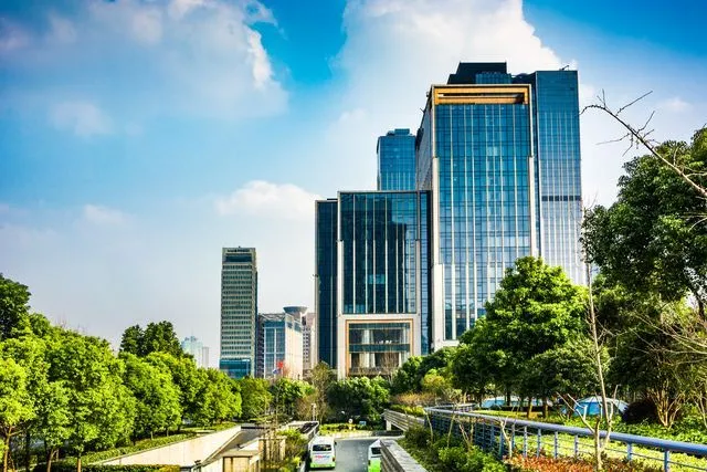 Modern office towers among trees