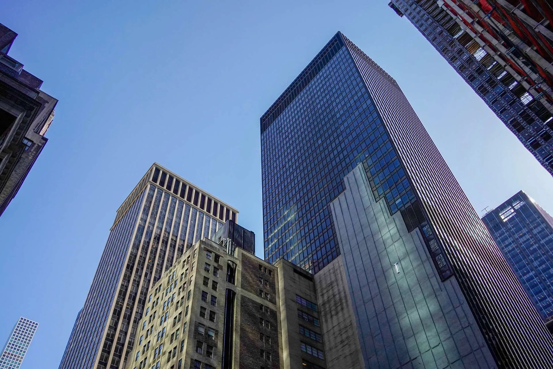 Looking up at Manhattan skyscrapers on a clear day