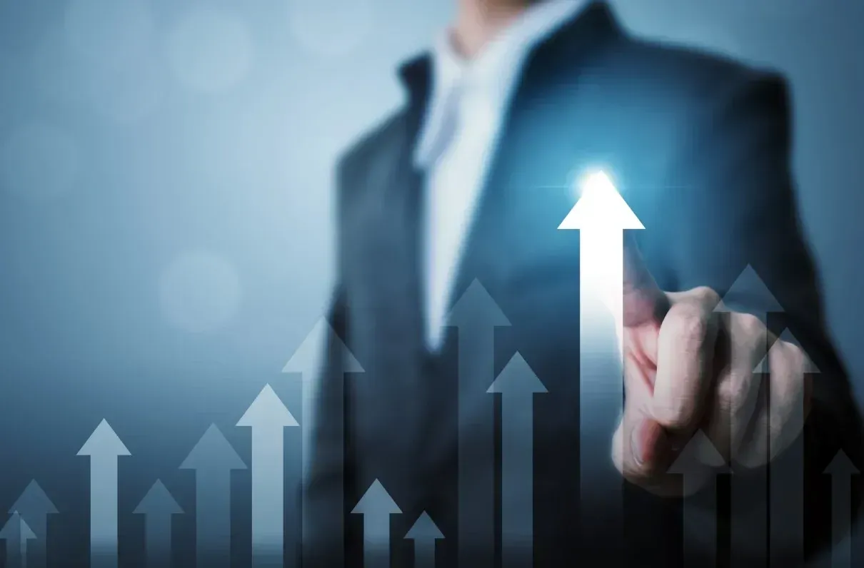 Investor pointing to a rising chart